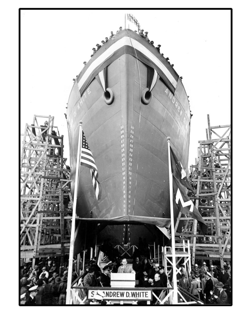 Photo shows personnel gathered around and on the Liberty-class S.S. Andrew Dickson White as it is readied for launch in 1943
