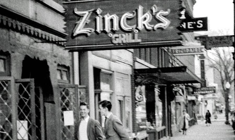 A black and white photo of two men outside Zinck's Grill