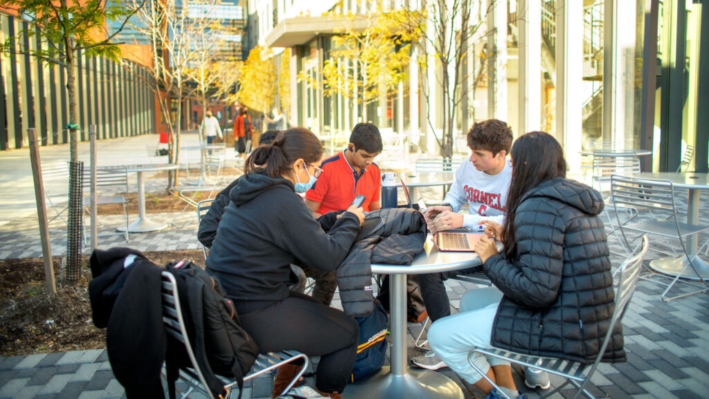 Students study at a table outside Toni Morrison Hall on North Campus