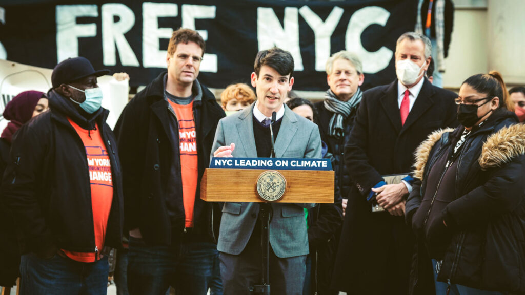 Ben Furnas standing at a podium in front of a crowd in NYC