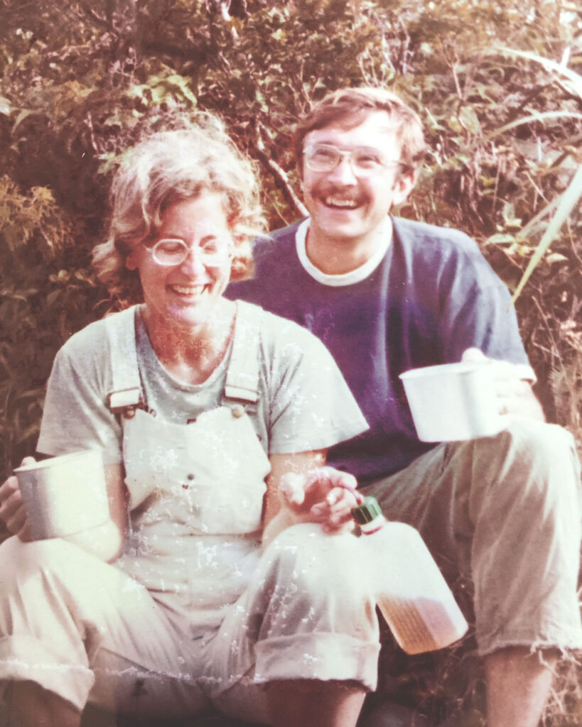 a faded photo of a couple outdoors drinking from cups