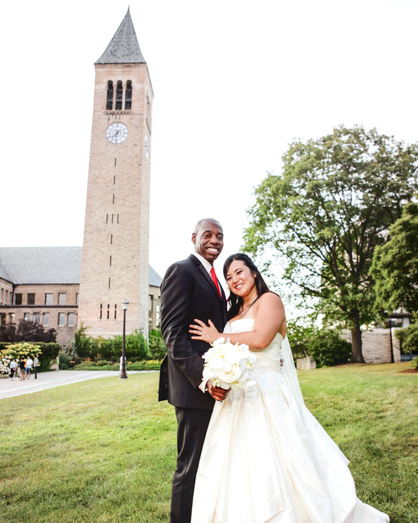A bridal couple in front of the Cornell clocktower