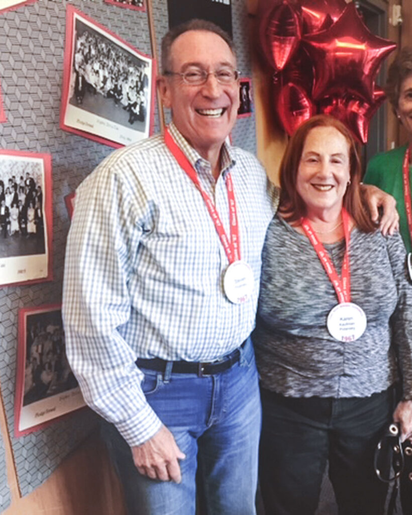 A couple with Cornell Reunion buttons around their necks