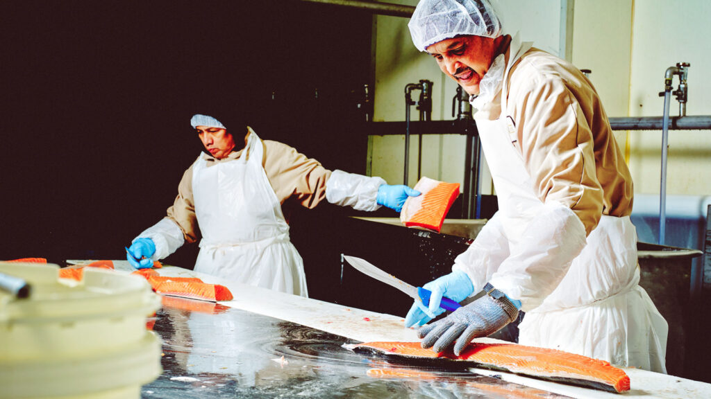 Acme employees Rogers Suarez, left, and Harry Kanhoye at work in the company's main processing facility