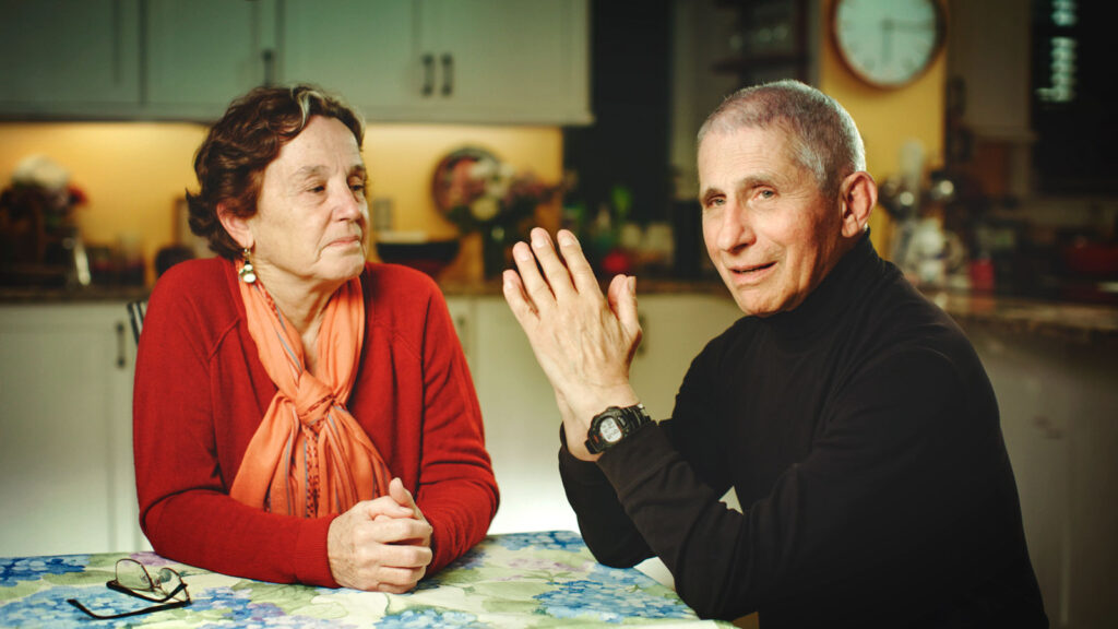 Dr. Anthony Fauci and Christine Grady sit at their kitchen table in December 2020.  