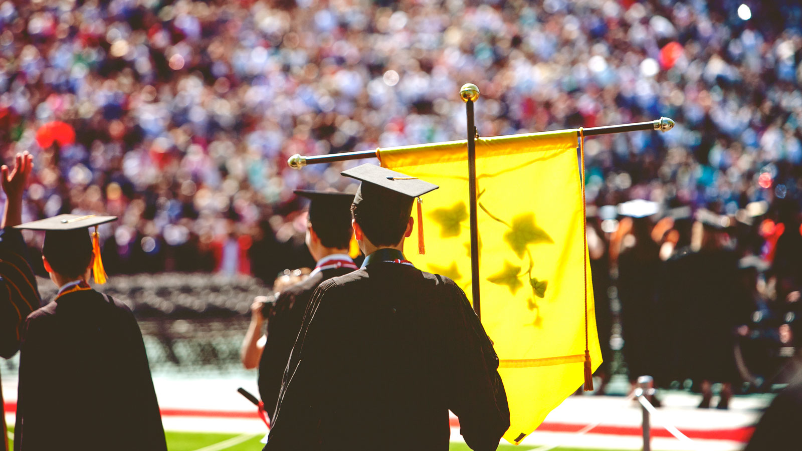 A banner being held at Commencement