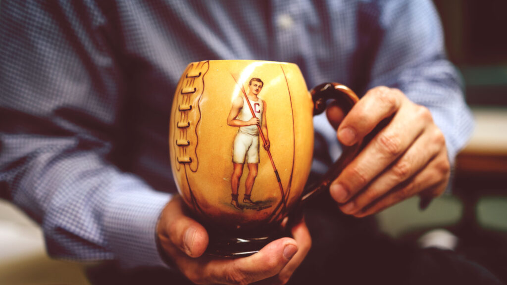 A Cornell rower is pictured on this football-shaped mug from 1905