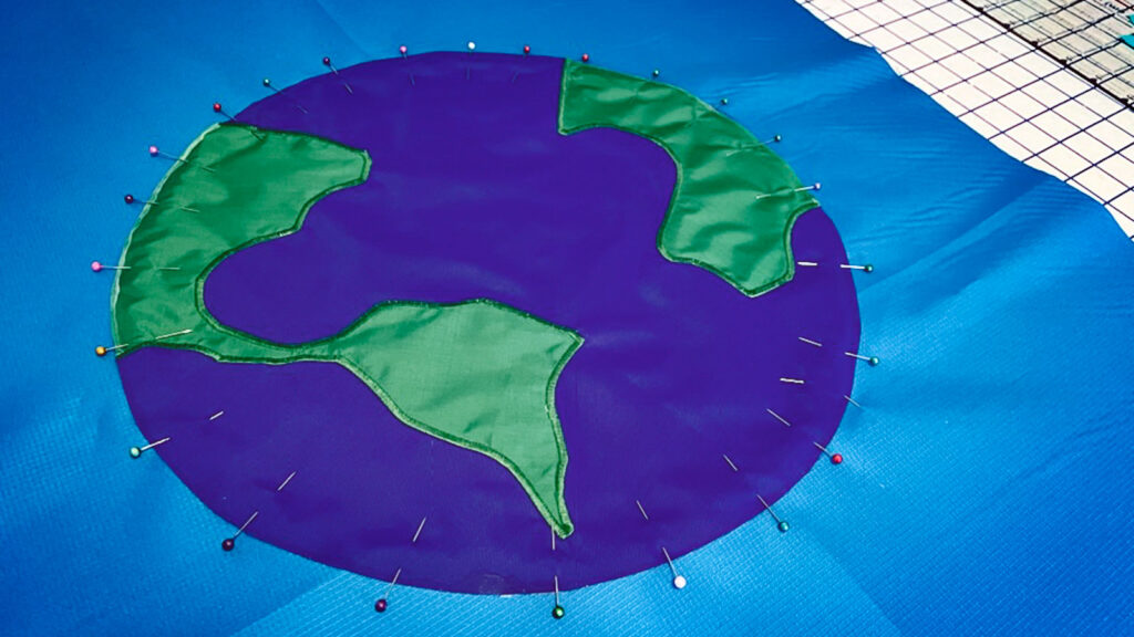 A close up of a banner with a pinned globe image