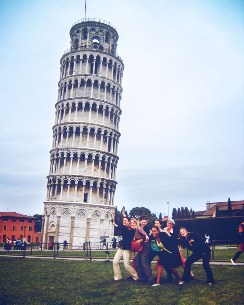 a group of women pretending to hold up the Leaning Tower of Pisa
