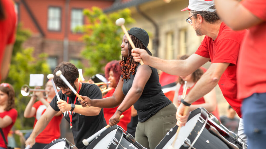 Members of the Big Red Marching Band, students and returning alumni, perform at Reunion