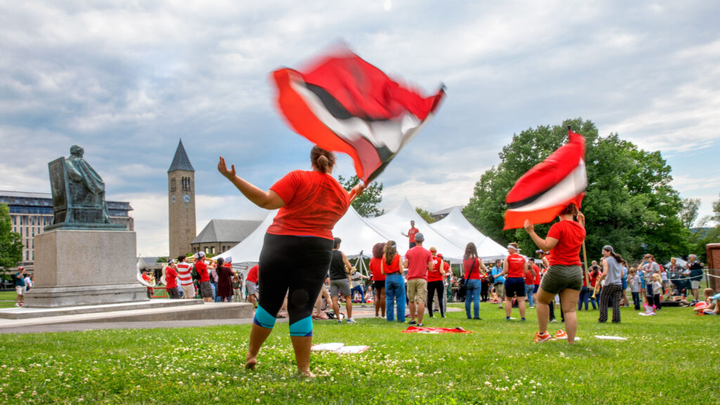 The Big Red Marching Band, complete with colorguard, performs on the Arts Quad during Reunion Weekend