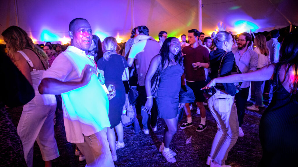 Alumni and guests dance at the tents on the Arts Quad Saturday night during Reunion Weekend