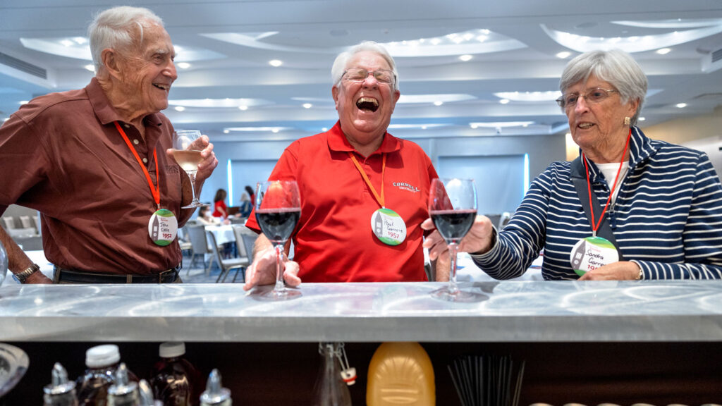 1950s classmates share wine and laughter at the Statler Hotel Ballroom