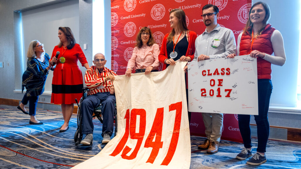 At the “Passing It Forward” Reunion ceremony, members of the oldest class attending present their class banner to the newest Reunion attendees