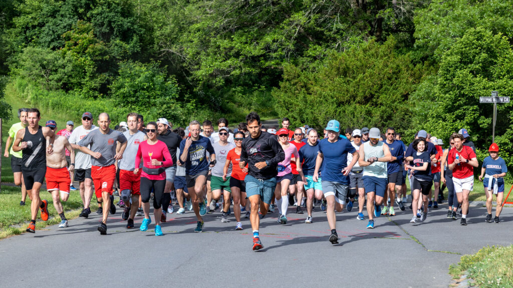 Participants in the Cornell Reunion 5K begin the run that loops through the Cornell Botanic Gardens Saturday morning of Reunion Weekend