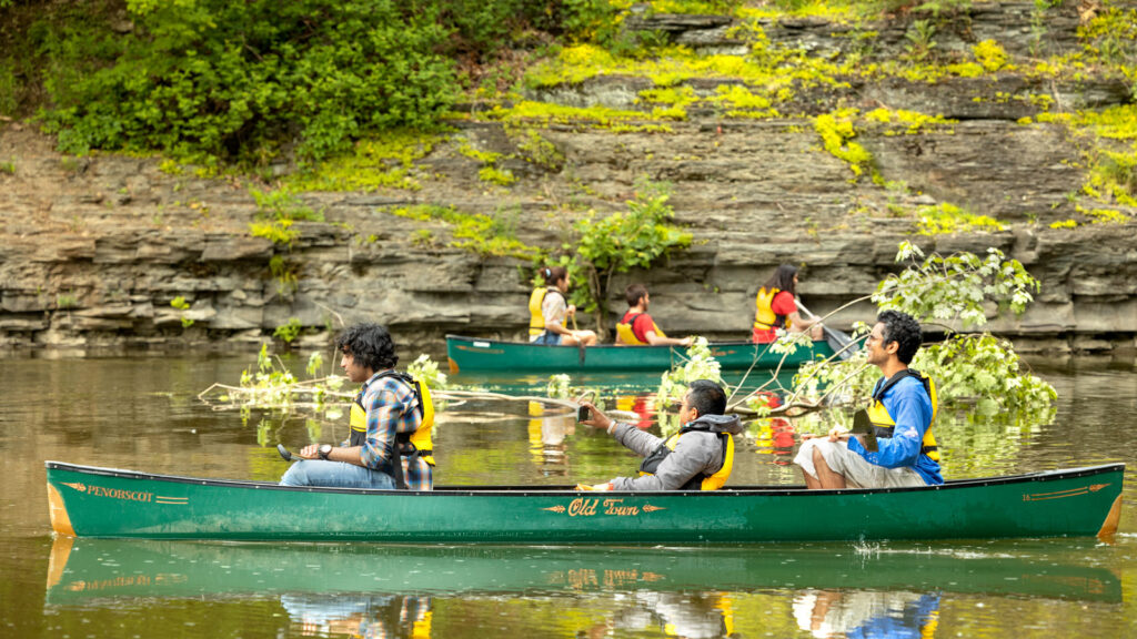 Alumni and family members canoe on Beebe Lake during Reunion Weekend