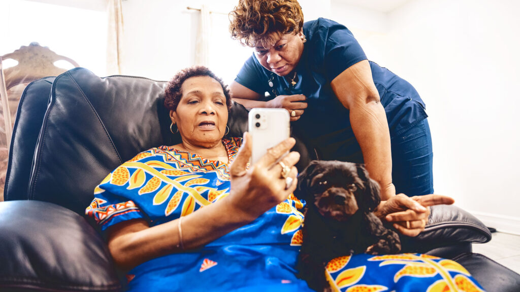 Home healthcare worker Marie and her patient, Yannick, using telehealth to talk to Dr. Madeline Sterling from Weill Cornell Medicine during a daily check-in.