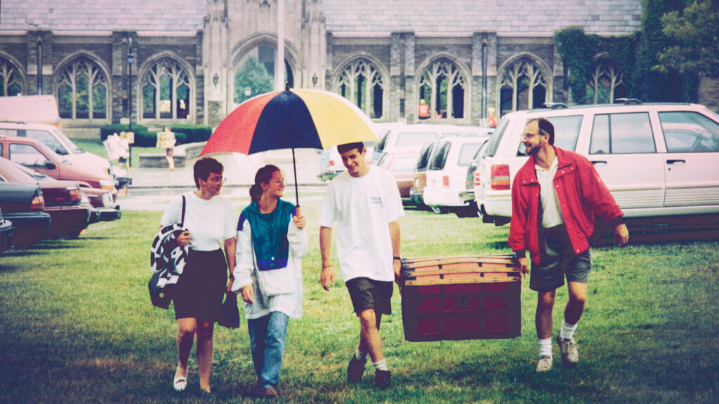 Family members help a student move in during the late 1990s