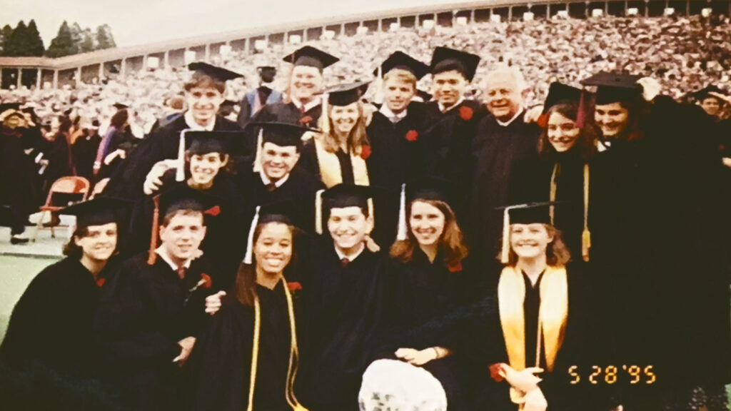 A group of college graduates posing in caps and gowns
