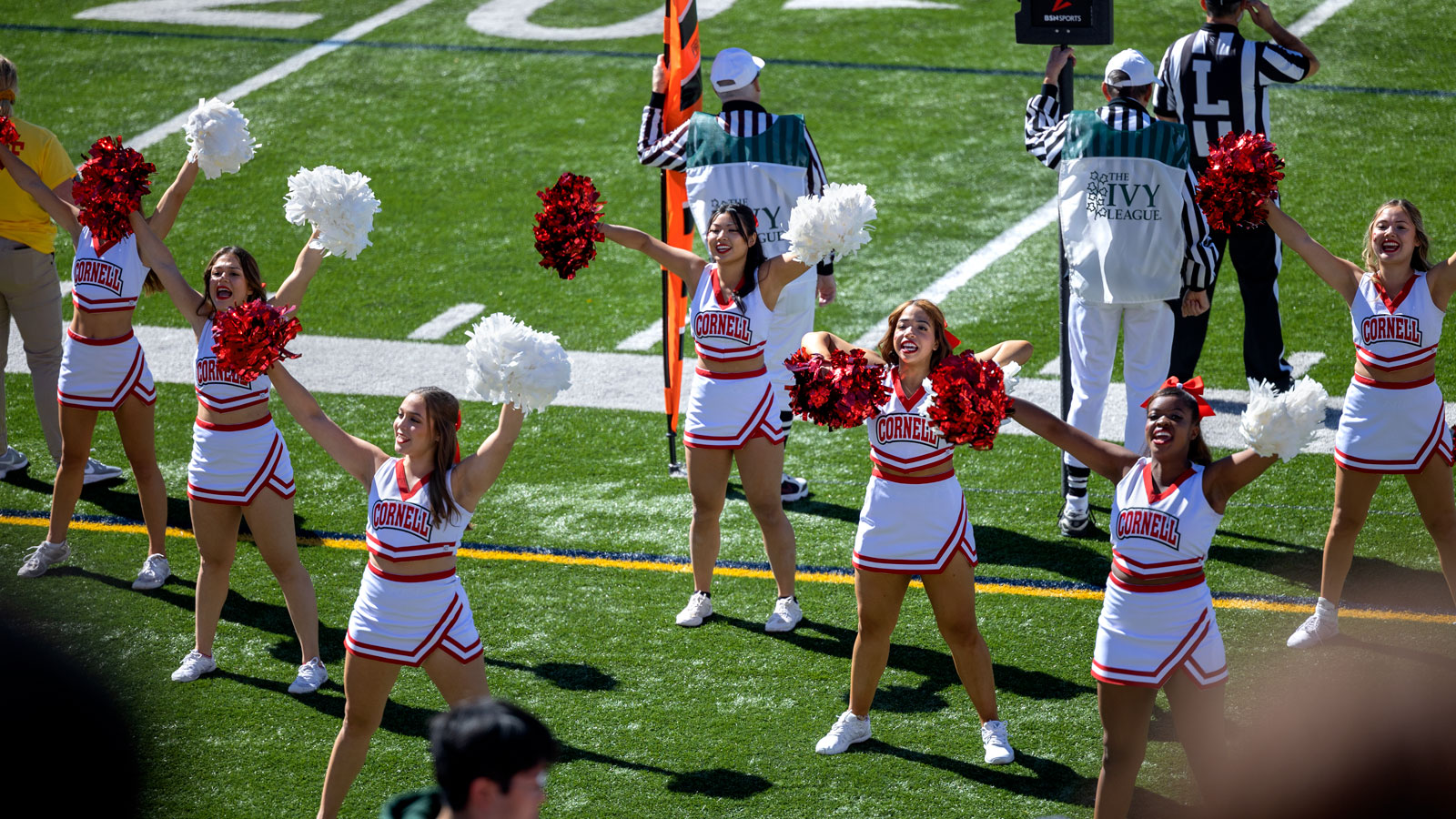 The Cornell Cheer team energizes the crowd at the Homecoming game at Schoellkopf