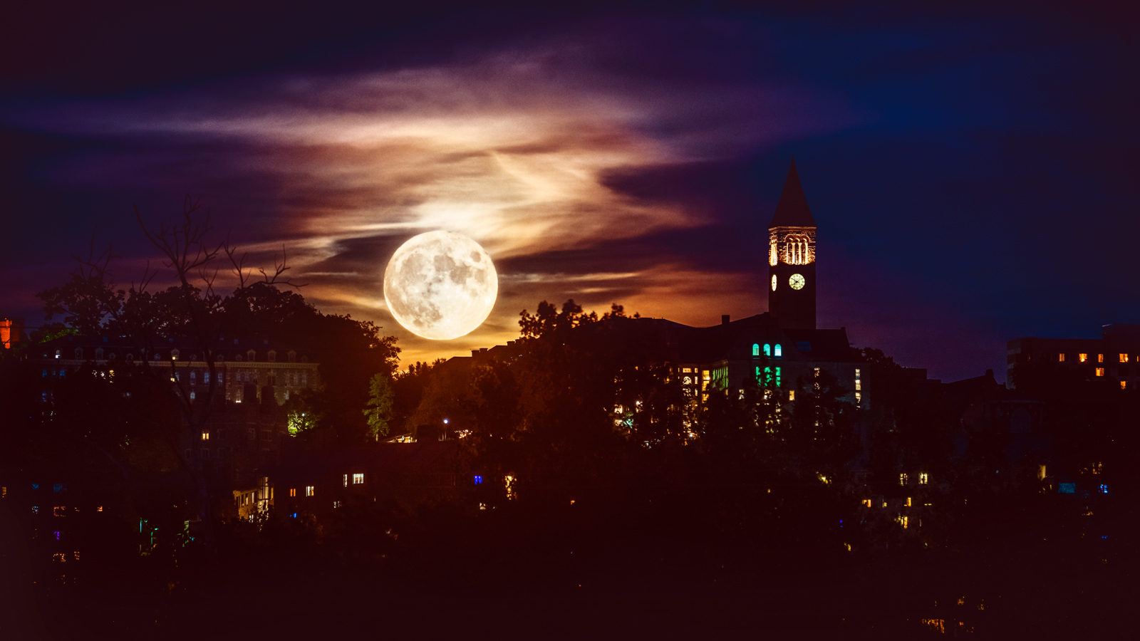 A spooky moon over the Cornell campus at night