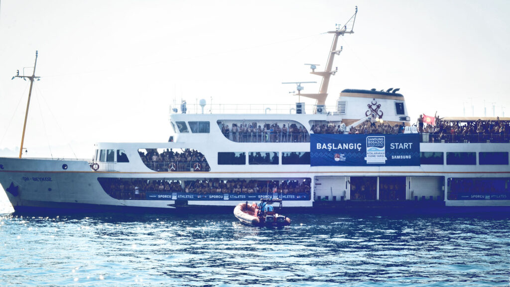 A boat filled with people during a swim race