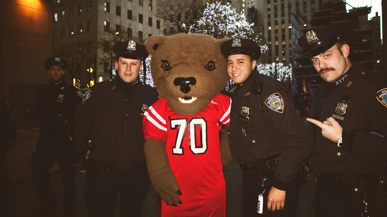 Cornell mascot Touchdown poses for a picture with New York City police officers at the Sy Katz Parade in New York City
