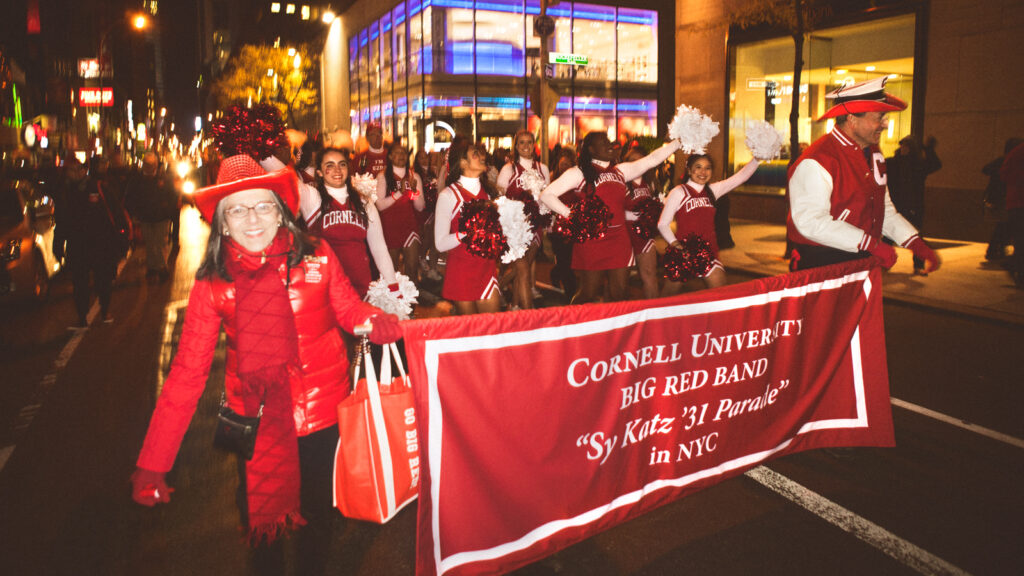 Cornell fans carry red banner during Sy Katz Parade in New York City