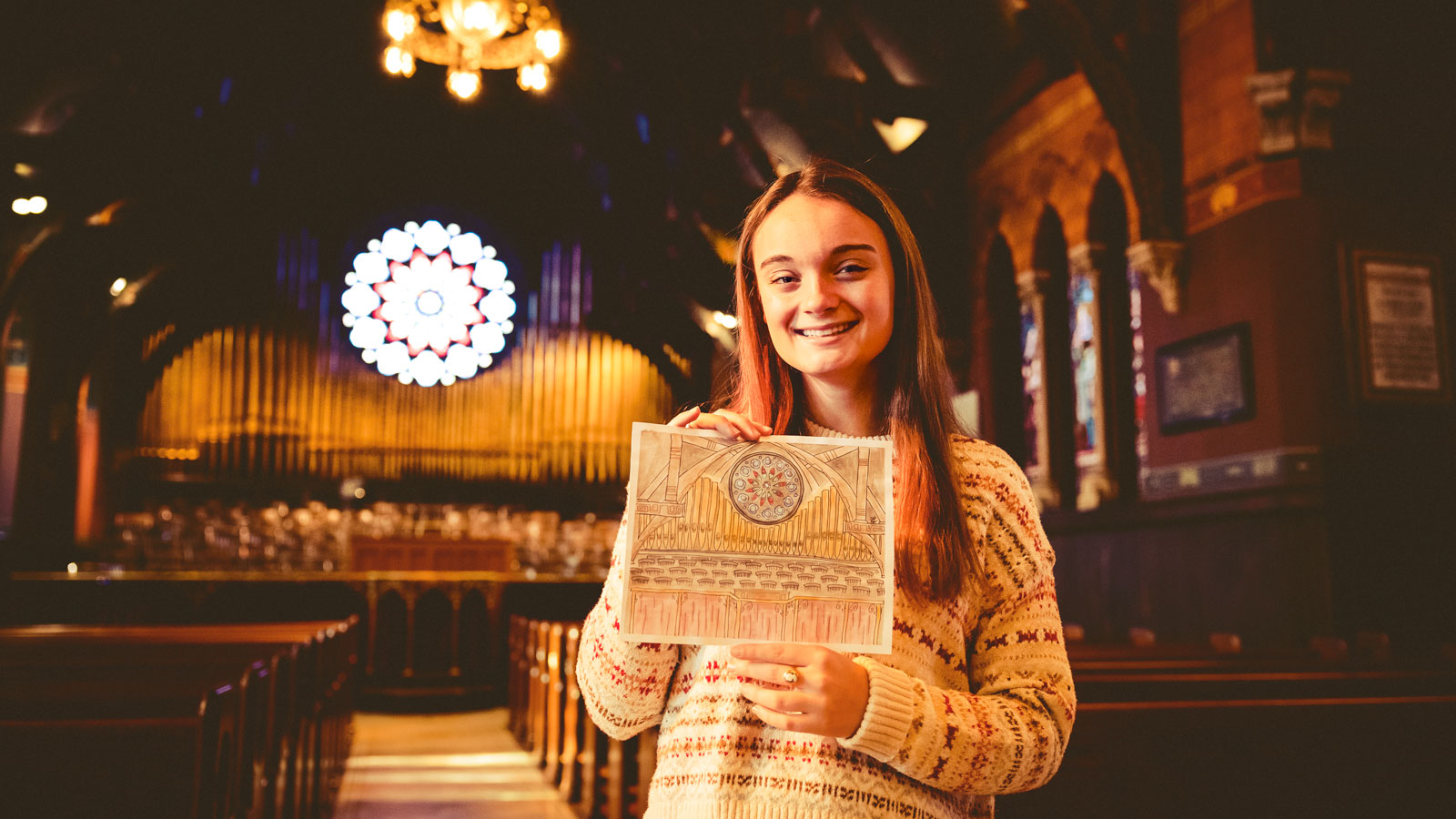 Grace Elmore in Sage Chapel with her drawing of it
