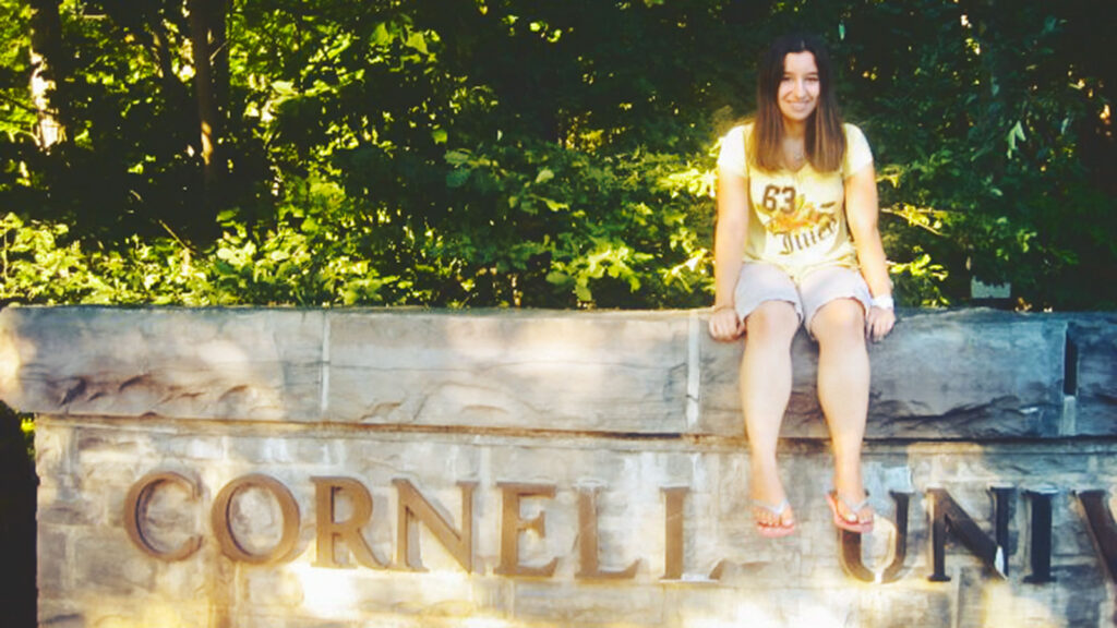 Ariel Cooper in high school on the Cornell sign