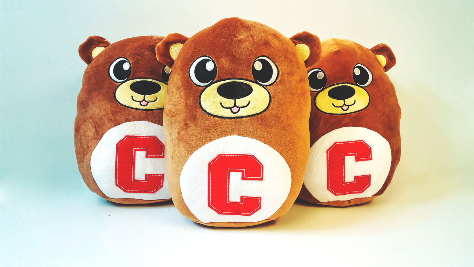 Three Cornell squishy bear pillows