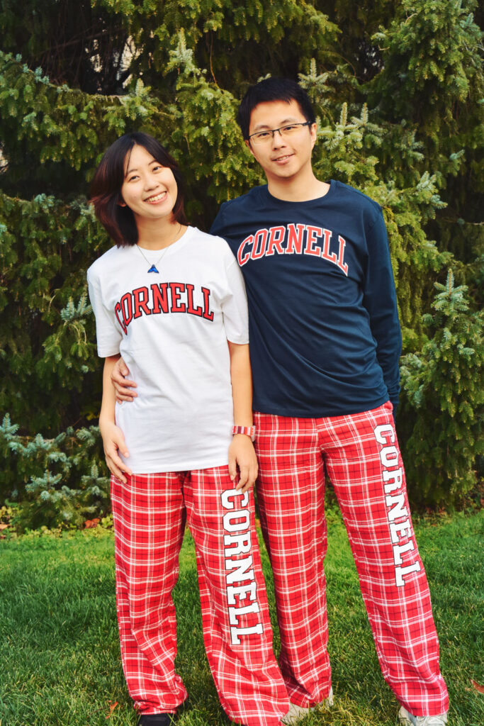 Male and female models in Cornell tartan pajamas