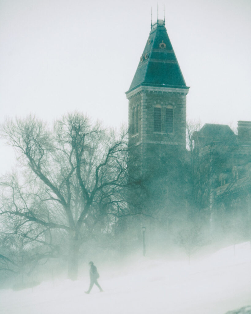 Person walks down the Slope below McGraw Hall