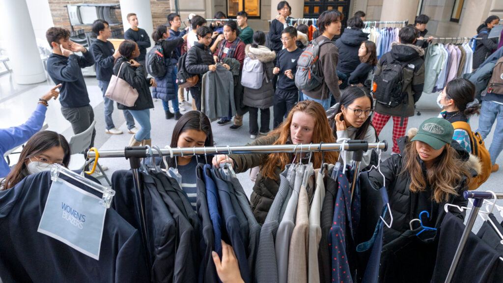 Students browse clothing selections at a pop up shop