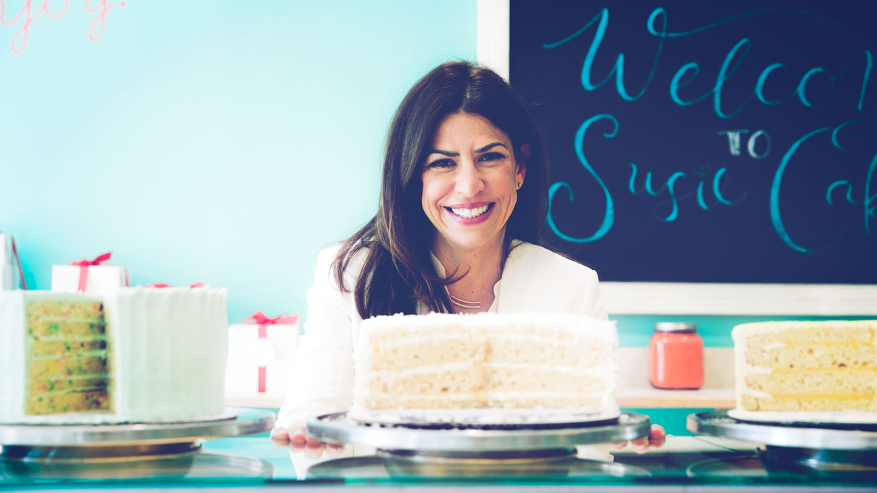Susan Sarich, owner of SusieCakes, with a cake