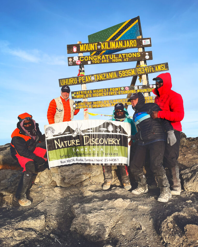 A group at the summit of Mt Kilimanjaro