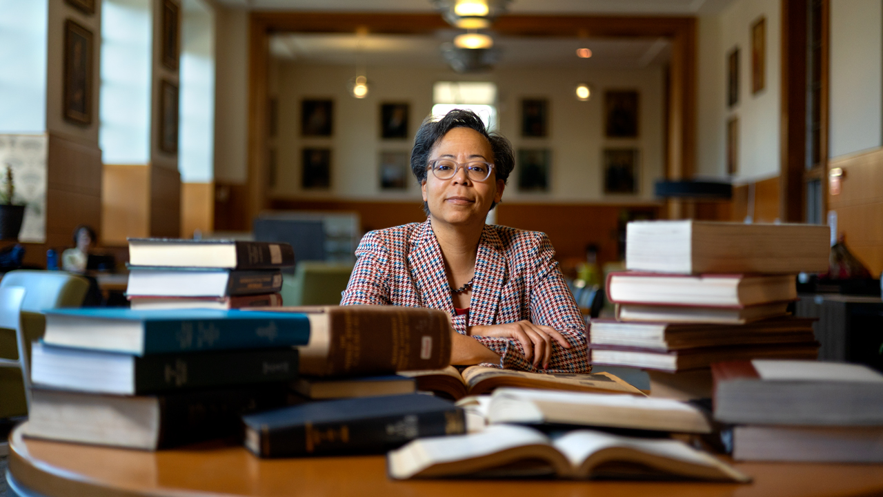 University Librarian Elaine Westbrooks with a pile of books