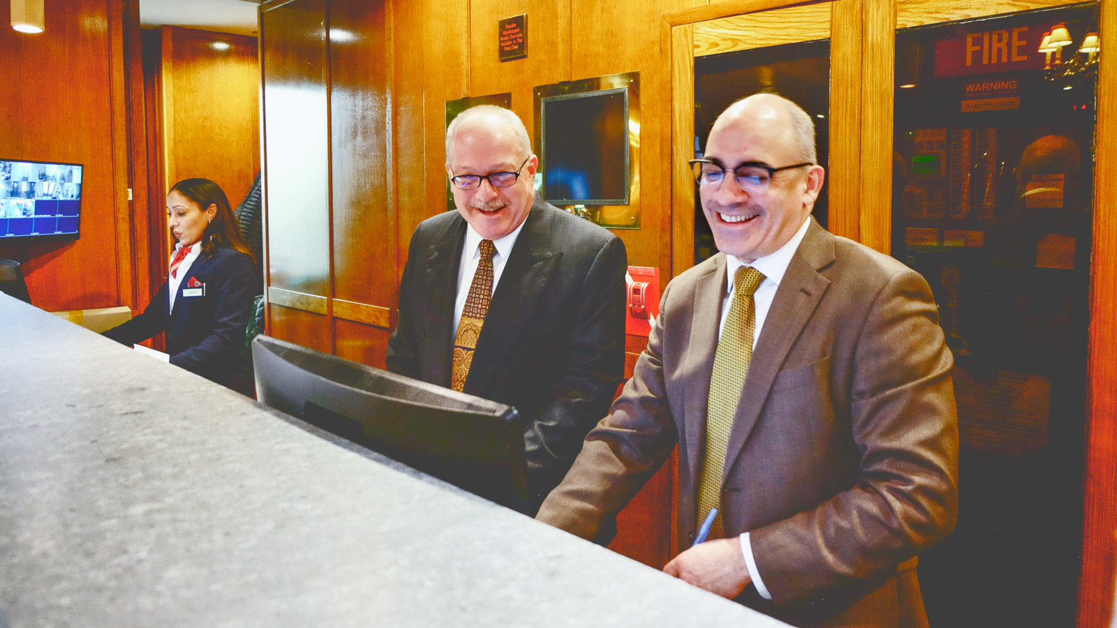 Craig Lasnier lends a hand behind the front desk of the Cornell Club