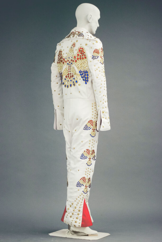 A 1970s-era Elvis Presley impersonator costume with red and blue rhinestones and silver stars.
