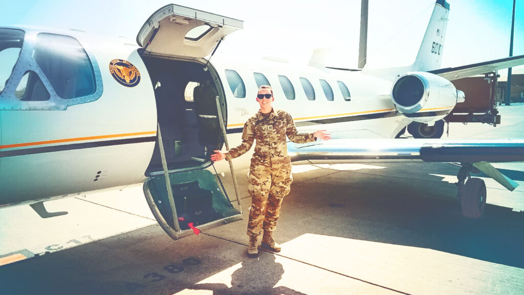 Veronica Yambrovich in front of a small jet plane in the Middle East