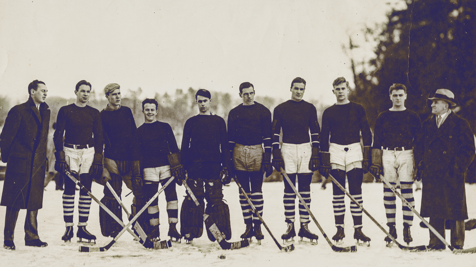 The Big Red men's hockey team during its Beebe Lake days, with head coach Nicky Bawlf pictured at right