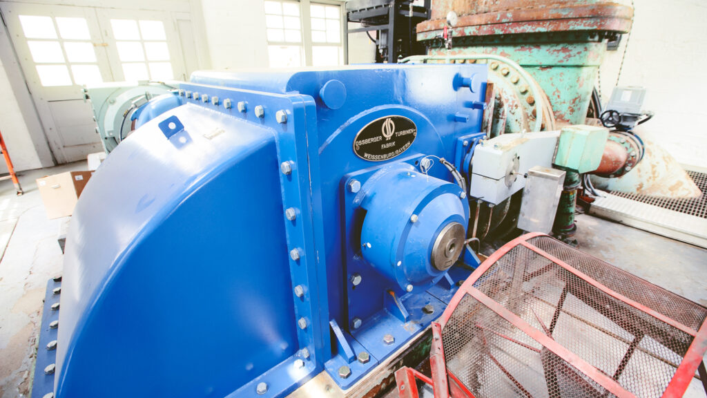 A large blue hydroelectric power turbine.