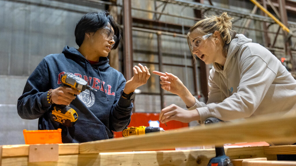 Angela Melugin ’23, right, works with Gabe Maurad ’26 at the High Voltage Laboratory.