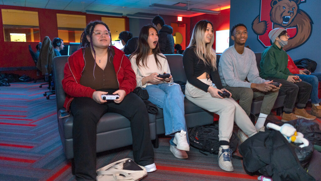 students sitting on a couch in the eSports gaming lounge in Robert Purcell Community Center