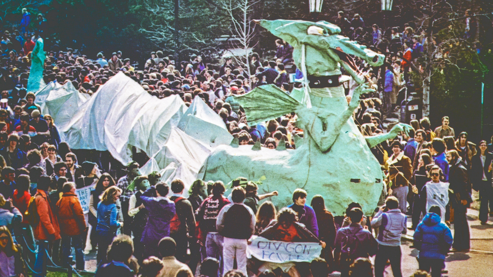 The 1979 dragon is shown surrounded by crowds during the parade
