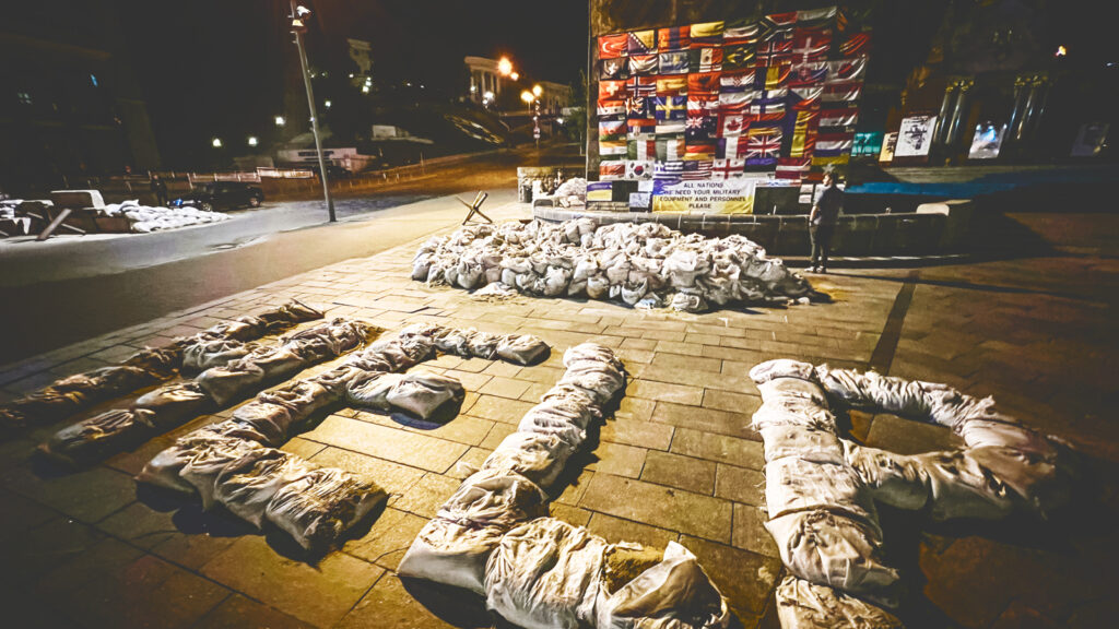 Large white sandbags spell the word help on a sidewalk in Kyiv, Ukraine