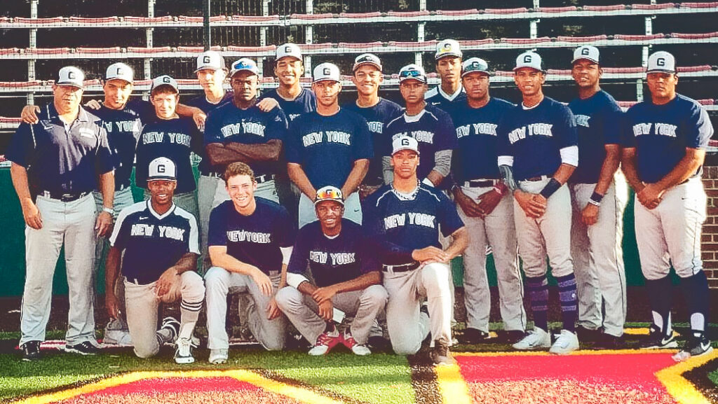 The New York Grays boys baseball team pose for a group shot in blue uniforms