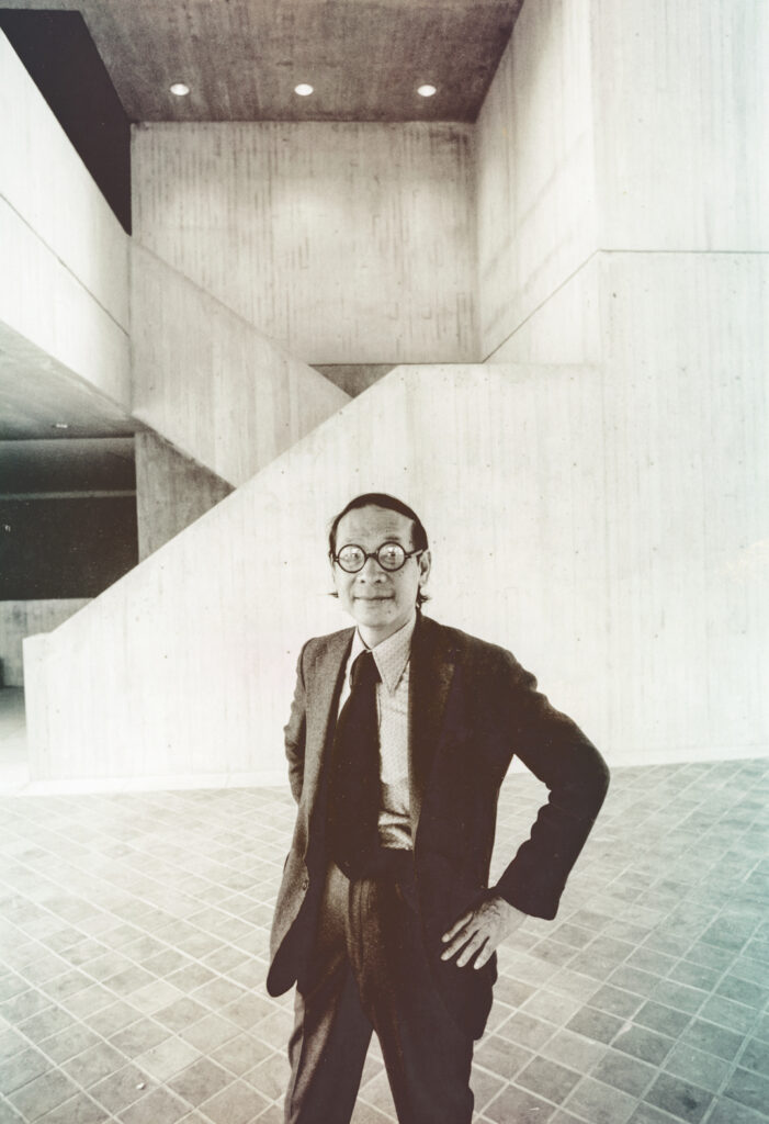 Architect I.M. Pei posing in a suit at the Johnson Museum of Art.