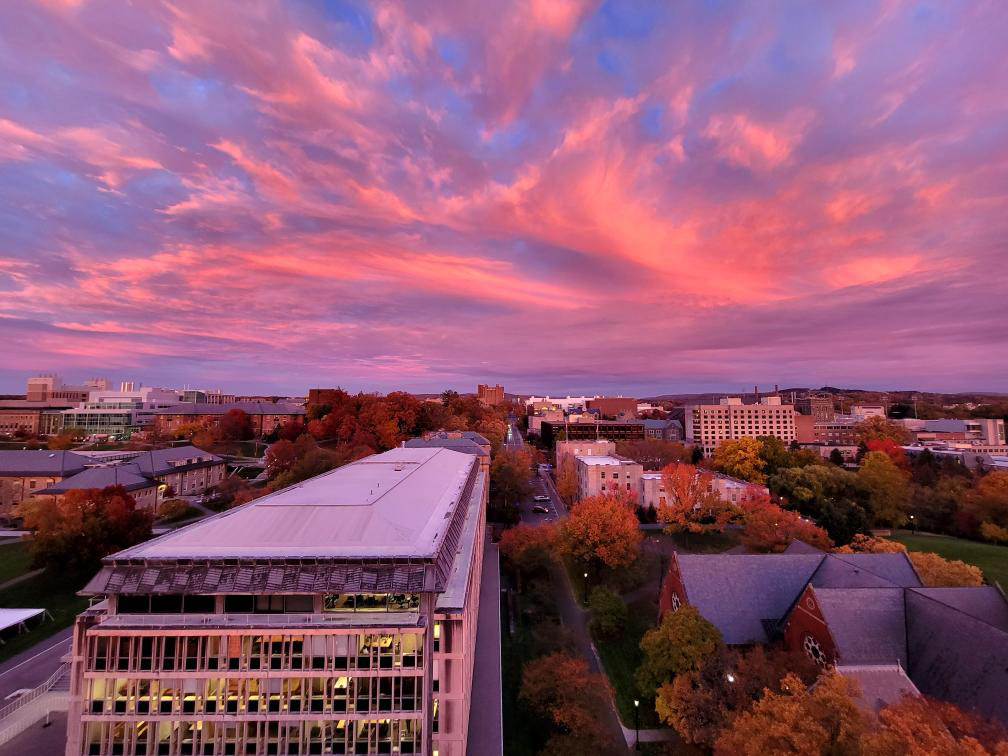 A swirling pink sunset over the Cornell University campus.