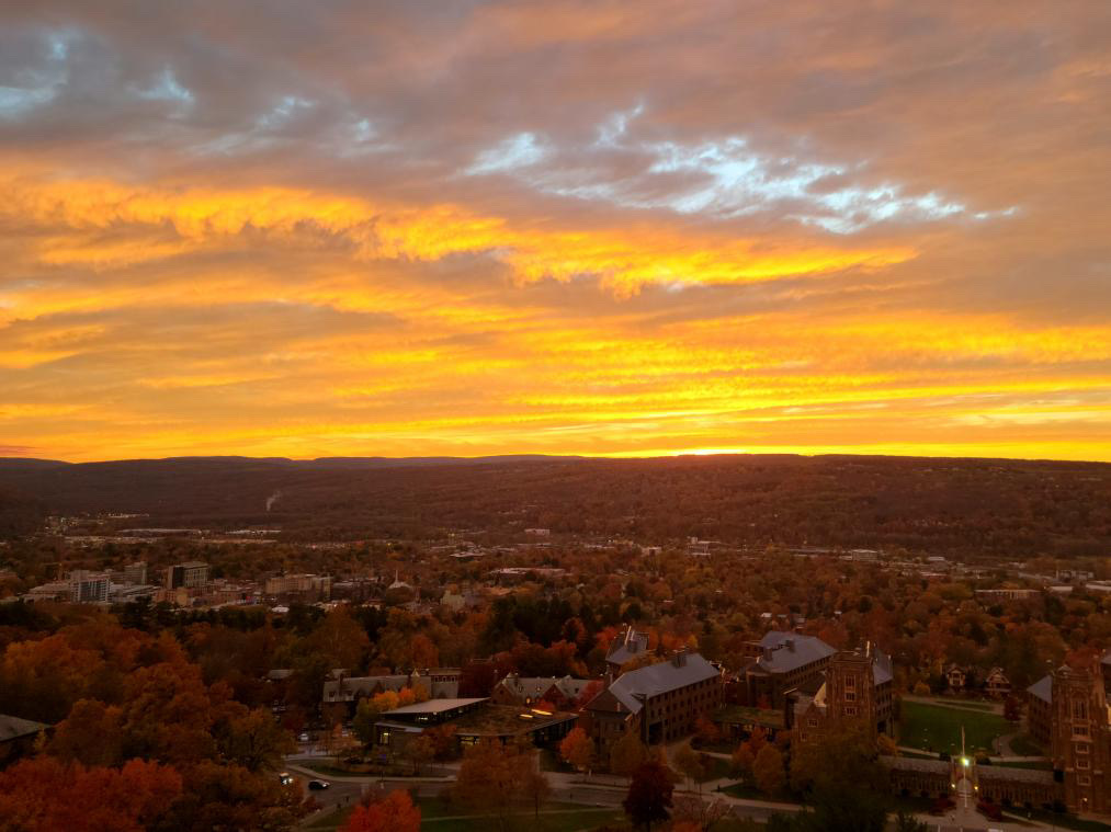 A yellow sunset above the Cornell University campus.